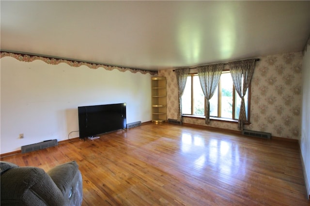 76 Broad St, West Bethlehem, PA 15345 - unfurnished living room featuring baseboards, wood finished floors, and visible vents