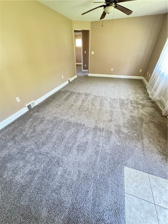 spare room featuring carpet flooring and ceiling fan