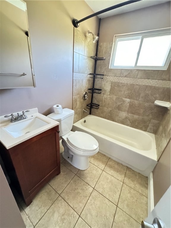 full bathroom featuring tiled shower / bath, vanity, tile patterned flooring, and toilet