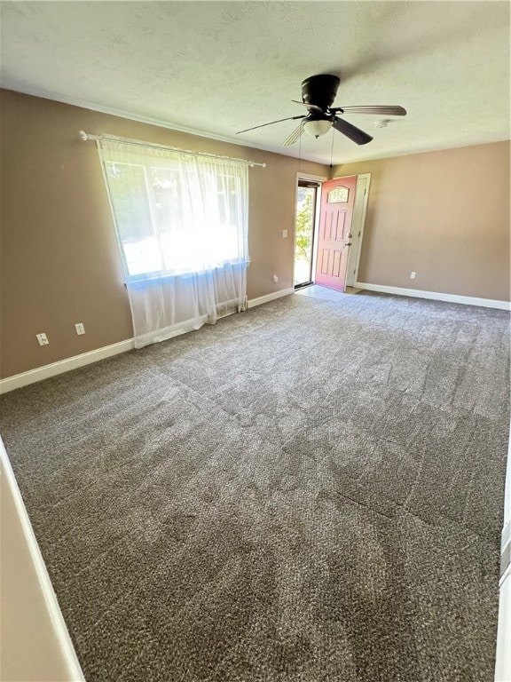 unfurnished room with ceiling fan, carpet floors, and a textured ceiling