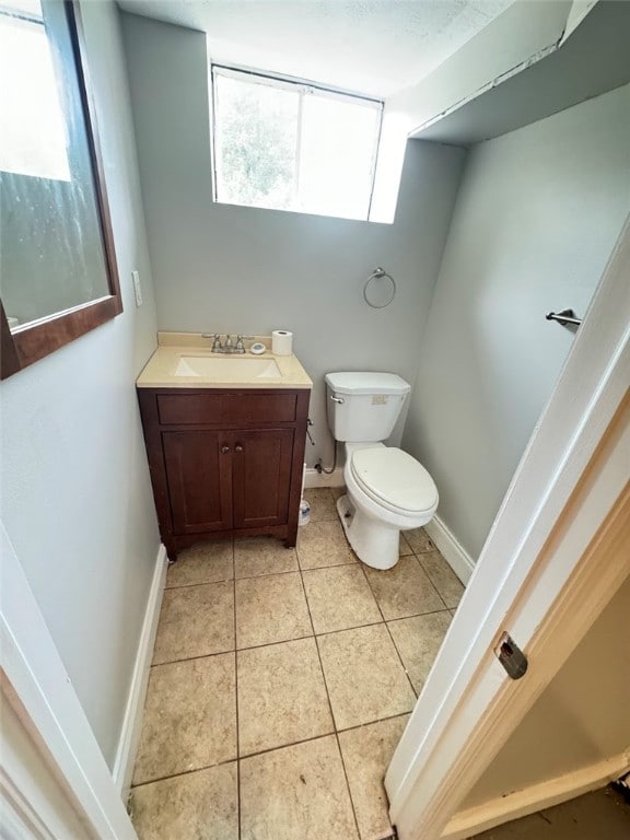 bathroom featuring tile patterned floors, vanity, and toilet