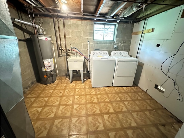 laundry room with water heater, washer and clothes dryer, and sink