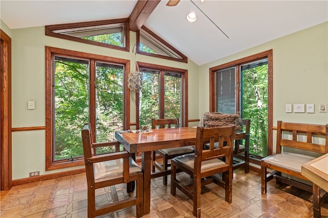 dining room with vaulted ceiling with beams, light parquet flooring, and a healthy amount of sunlight