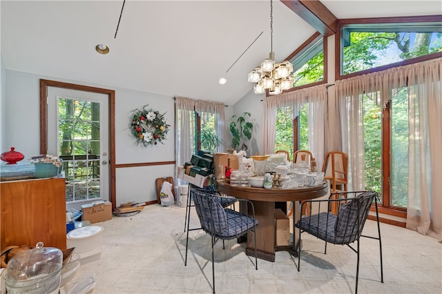 dining area with lofted ceiling with beams and a wealth of natural light