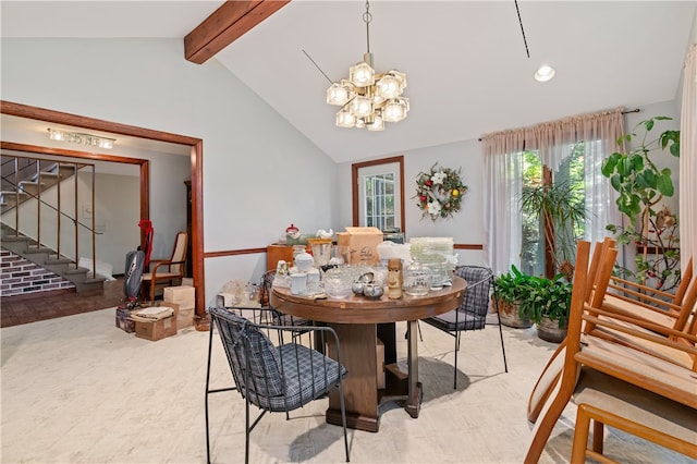 dining area featuring lofted ceiling with beams, plenty of natural light, and an inviting chandelier