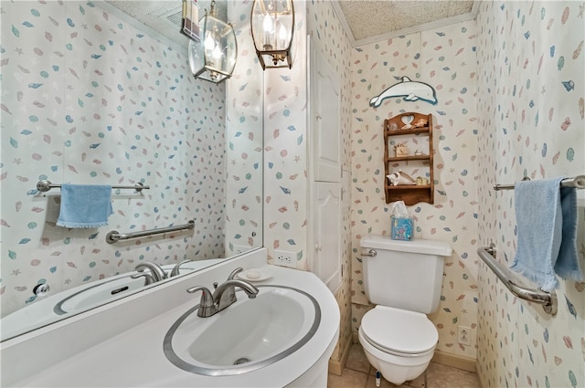 bathroom featuring tile patterned flooring, vanity, a textured ceiling, and toilet