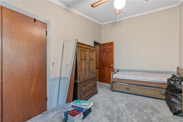 carpeted bedroom featuring ornamental molding and ceiling fan