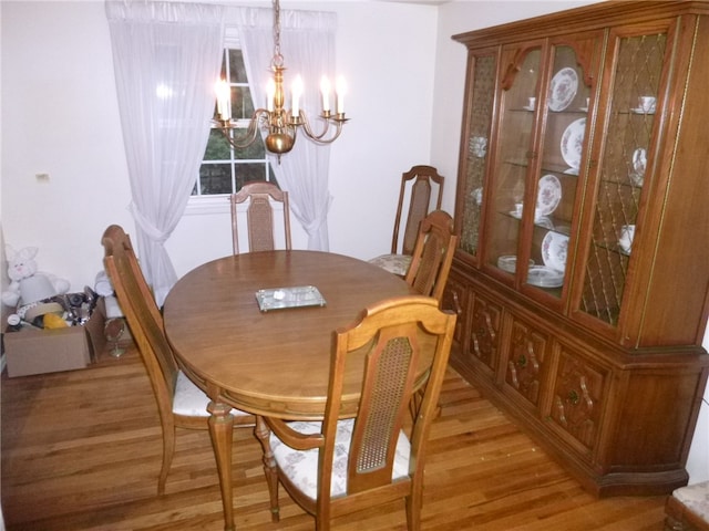 dining room featuring a chandelier and light wood-type flooring