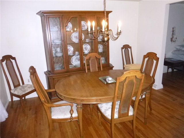 dining room featuring a chandelier and dark hardwood / wood-style floors