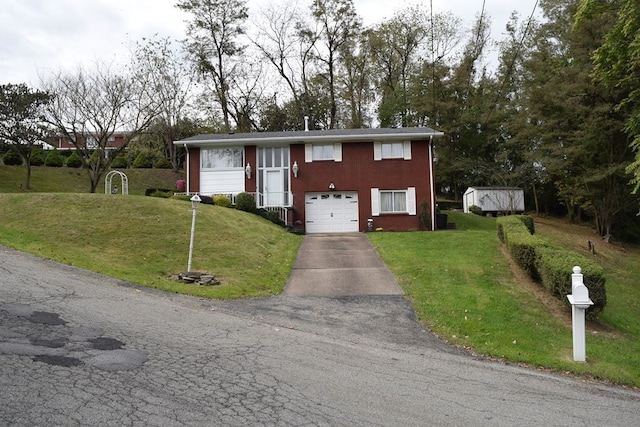 split foyer home featuring a front yard, a garage, and a storage unit