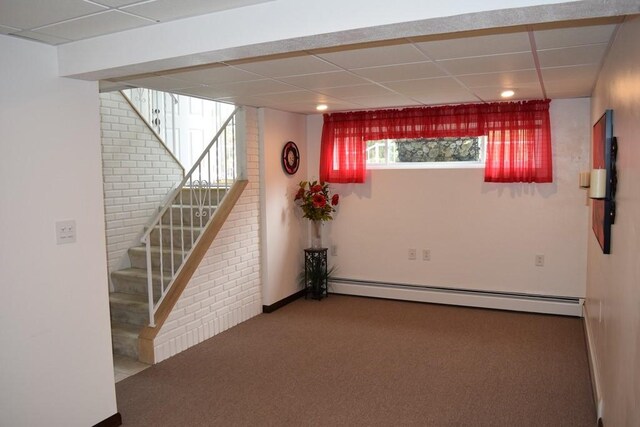 720 Pollard St, Monessen, PA 15062 - basement with a healthy amount of sunlight, stairway, a paneled ceiling, a baseboard radiator, and carpet