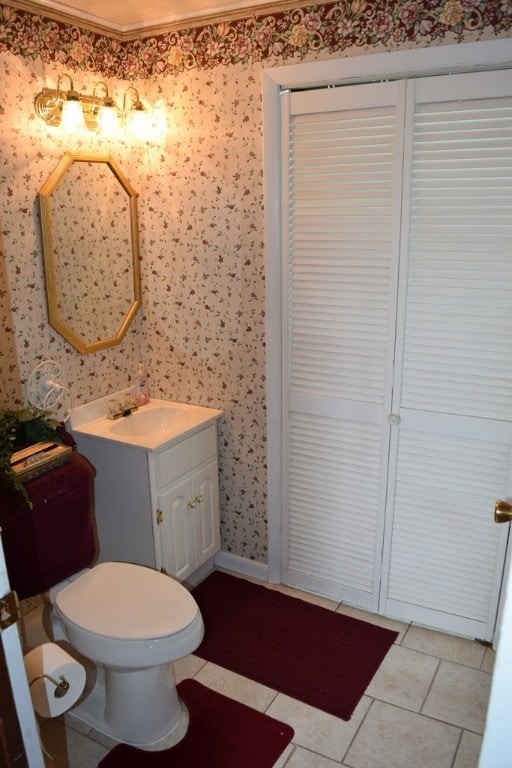 bathroom featuring vanity, tile patterned flooring, and toilet