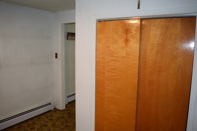 hallway with a baseboard radiator and ornamental molding