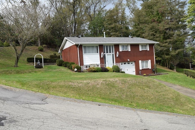 raised ranch with a front yard and a garage