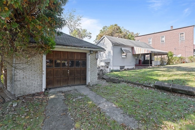 view of side of property featuring a yard and a garage