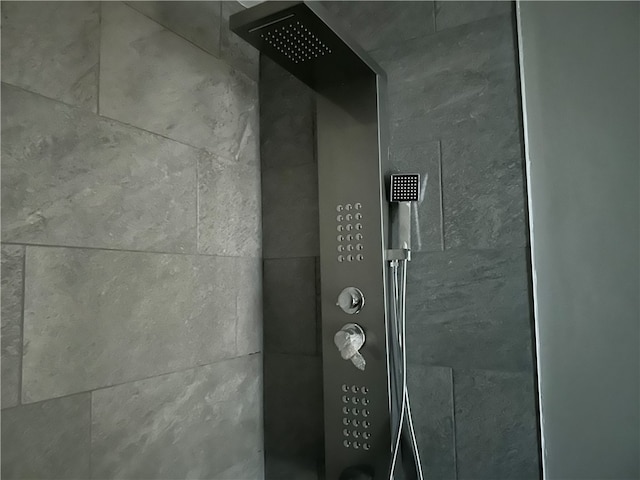 interior details with a tile shower