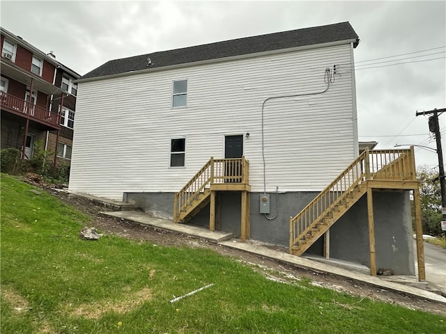 rear view of property featuring a yard