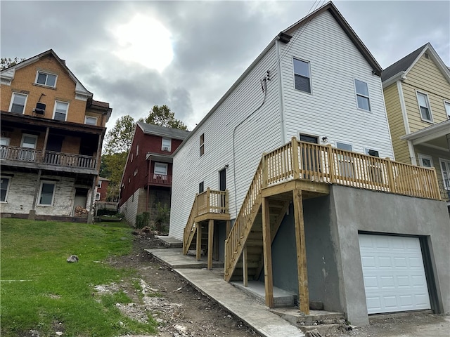 rear view of property with a garage and a lawn