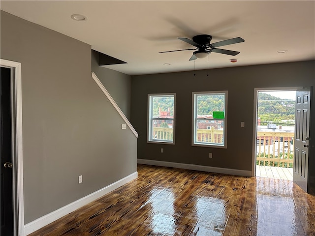 spare room with ceiling fan and dark hardwood / wood-style floors