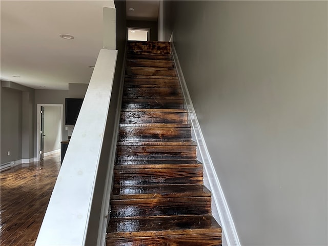 staircase featuring hardwood / wood-style flooring