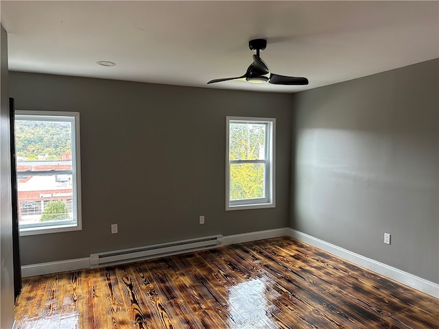 unfurnished room featuring ceiling fan, baseboard heating, and dark hardwood / wood-style floors