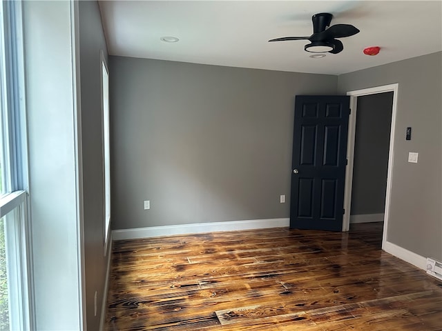 unfurnished room featuring ceiling fan and dark hardwood / wood-style floors