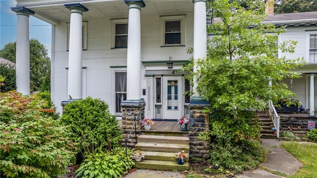 view of exterior entry with covered porch