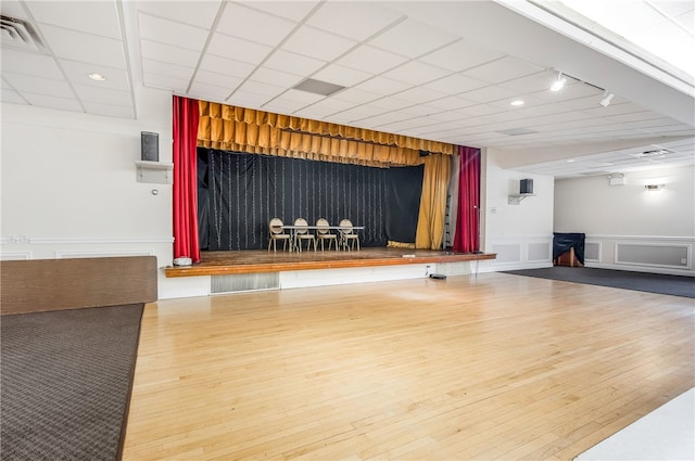 workout room featuring a drop ceiling and hardwood / wood-style flooring