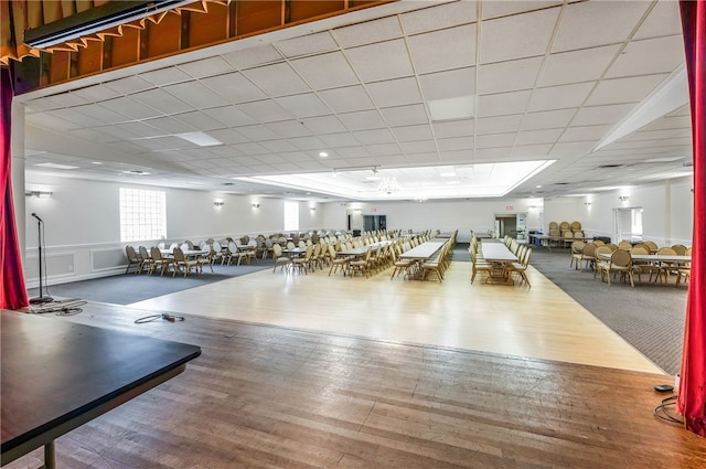 workout area featuring hardwood / wood-style flooring and a drop ceiling