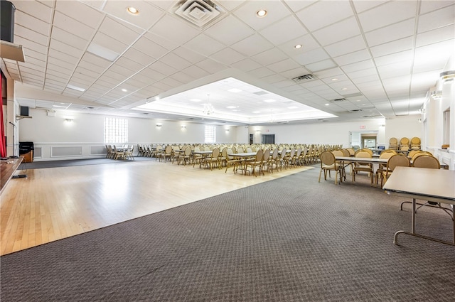 miscellaneous room with a drop ceiling and hardwood / wood-style flooring