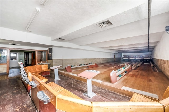 interior space featuring a textured ceiling and a bowling alley