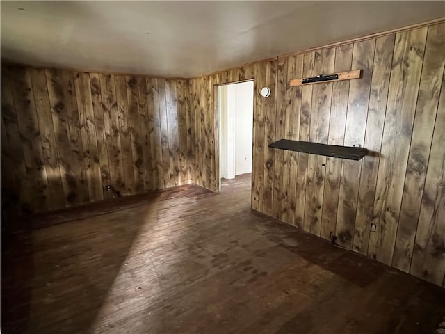 spare room with wood walls