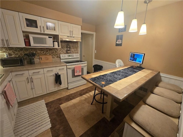 kitchen featuring white cabinetry, white appliances, tasteful backsplash, and pendant lighting