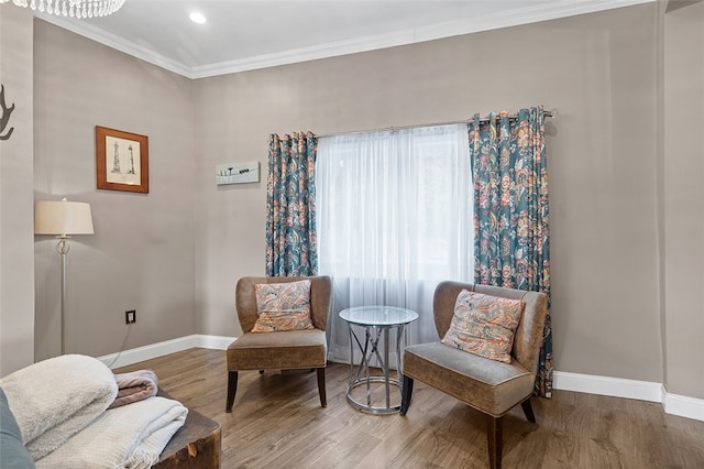 sitting room featuring hardwood / wood-style floors and crown molding