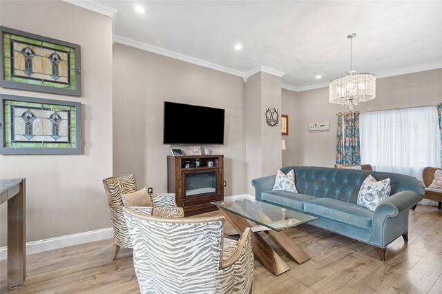 living room with light hardwood / wood-style flooring, a notable chandelier, and crown molding