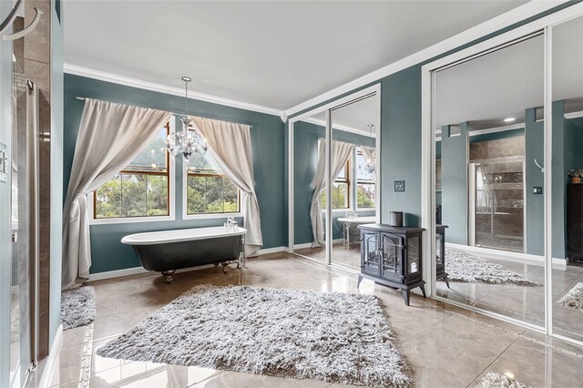 sitting room with an inviting chandelier, ornamental molding, and plenty of natural light