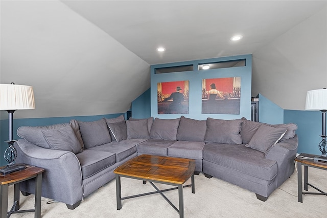 living room with vaulted ceiling and light colored carpet