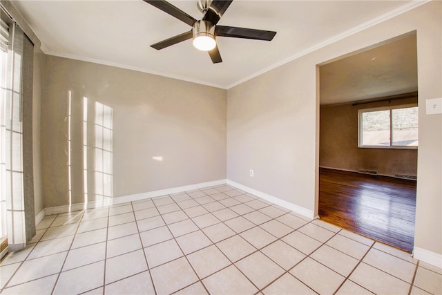 empty room with ornamental molding, ceiling fan, and light hardwood / wood-style flooring