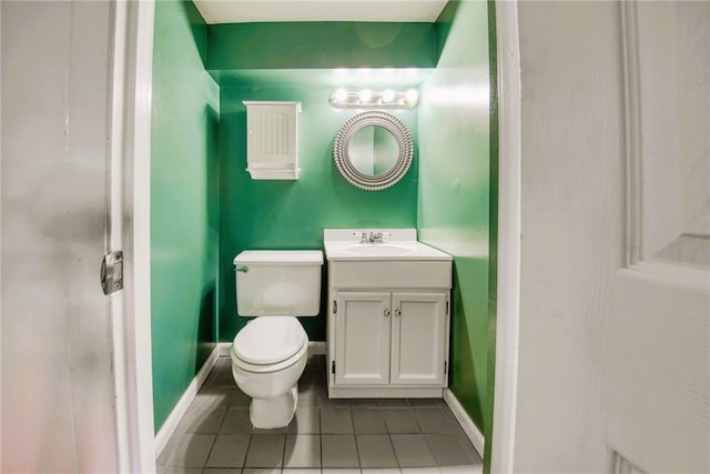 bathroom with tile patterned flooring, vanity, and toilet