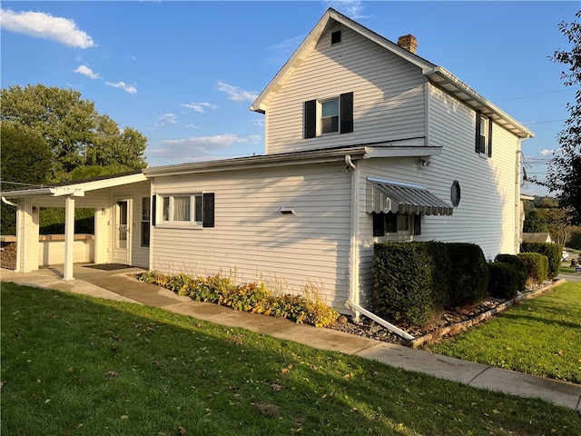 view of front facade with a front lawn and a carport