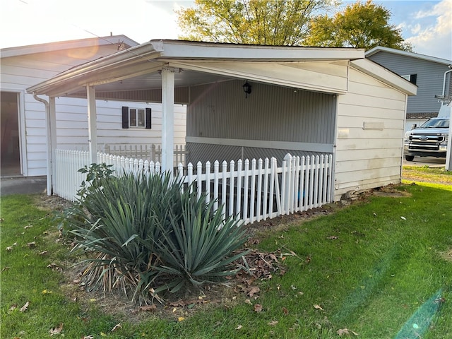 view of side of home with a yard