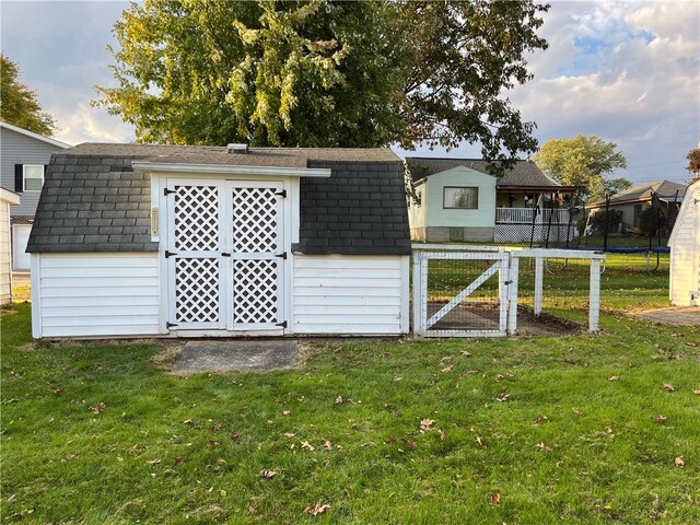 view of outbuilding featuring a yard