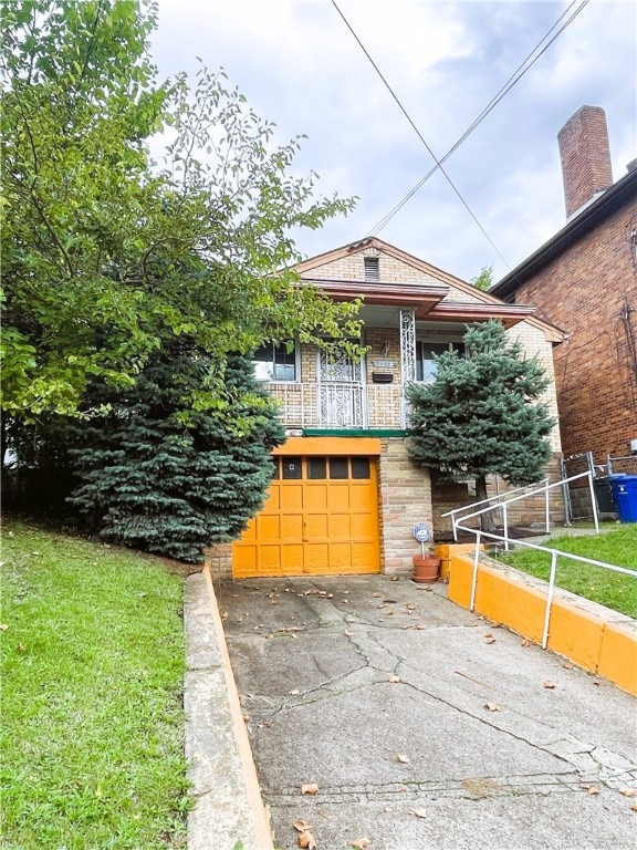 view of front facade with a garage, a balcony, and a front lawn