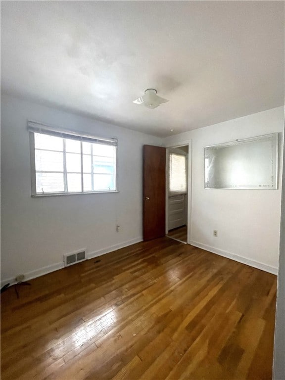 empty room with dark wood-type flooring