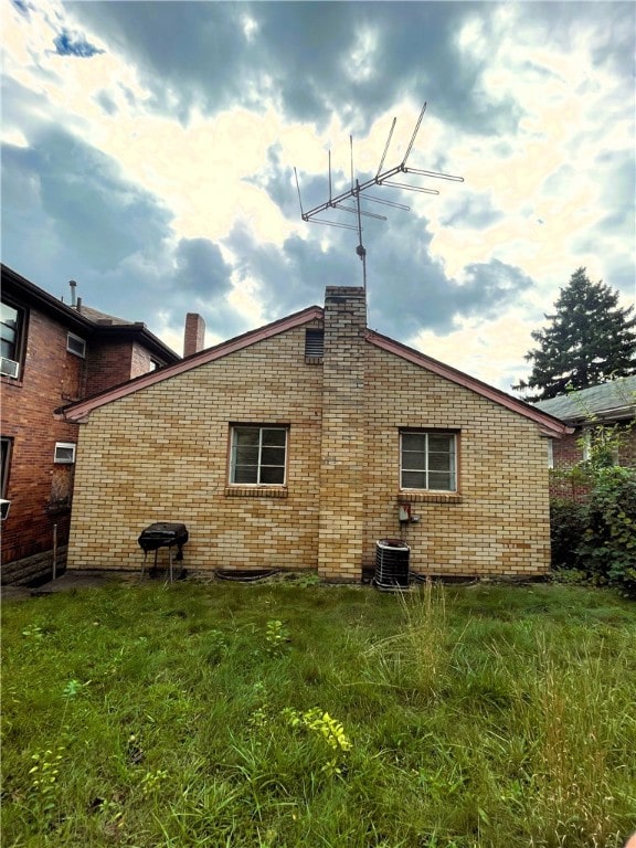 rear view of property with central AC unit