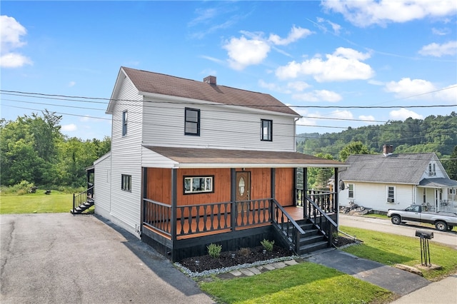 view of front of property with a front lawn and covered porch