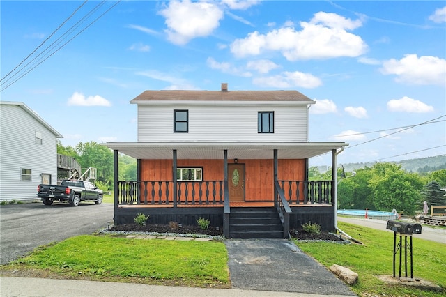 view of front of house featuring a porch and a front lawn