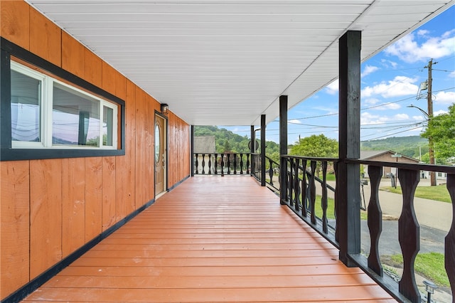 wooden terrace featuring covered porch