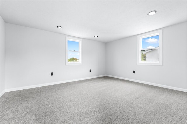 spare room featuring carpet flooring and a healthy amount of sunlight