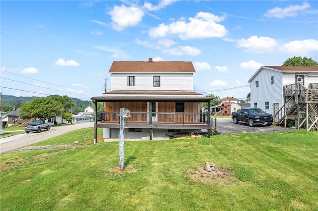 view of front of property with a front yard and a porch